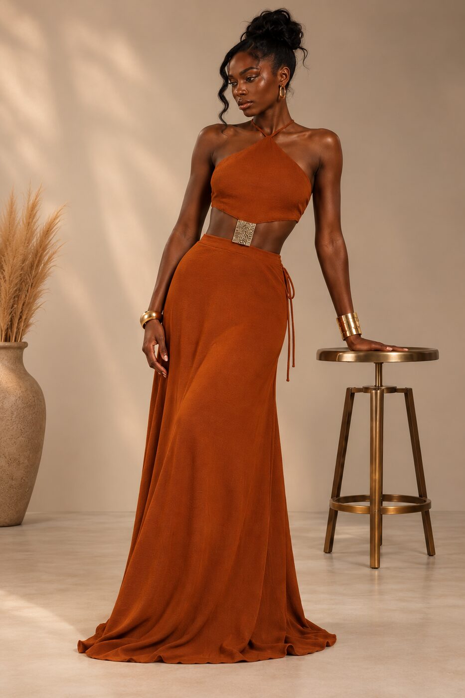 THE Solara Dress — burnt orange halter neck maxi dress with gold waist accent, front view